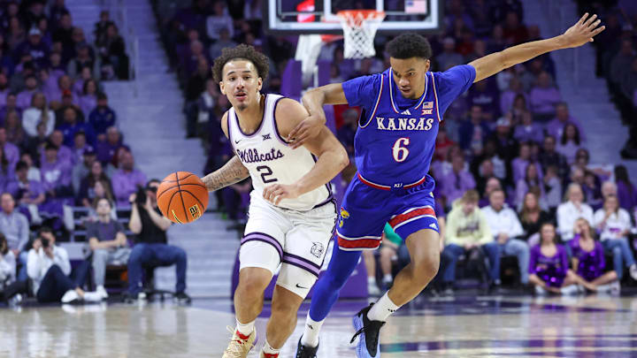 Feb 8, 2025; Manhattan, Kansas, USA; Kansas State Wildcats guard Max Jones (2) dribbles by Kansas Jayhawks guard Rylan Griffen (6) during the first half at Bramlage Coliseum. Mandatory Credit: Scott Sewell-Imagn Images