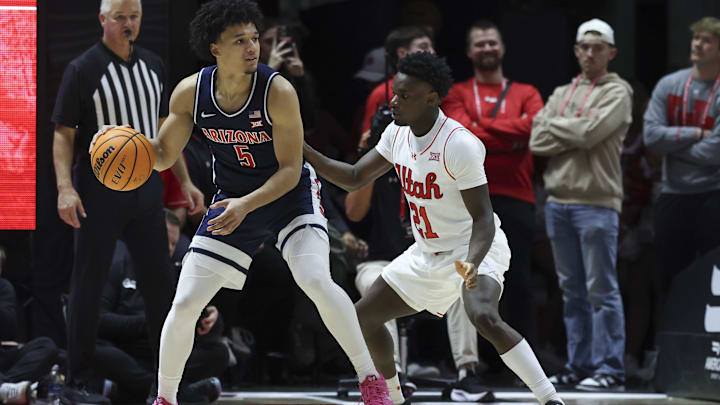 Jan 3, 2026; Salt Lake City, Utah, USA; Arizona Wildcats guard Brayden Burries (5) posts up against Utah Utes guard Obomate Abbey (21) during the second half at Jon M. Huntsman Center. Mandatory Credit: Rob Gray-Imagn Images
