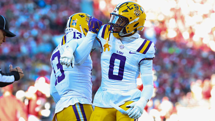 Nov 29, 2025; Norman, Oklahoma, USA;  Louisiana State Tigers defensive back A.J. Haulcy (13) and Louisiana State Tigers safety Tamarcus Cooley (0) react during the first half against the Oklahoma Sooners at Gaylord Family-Oklahoma Memorial Stadium. Mandatory Credit: Kevin Jairaj-Imagn Images