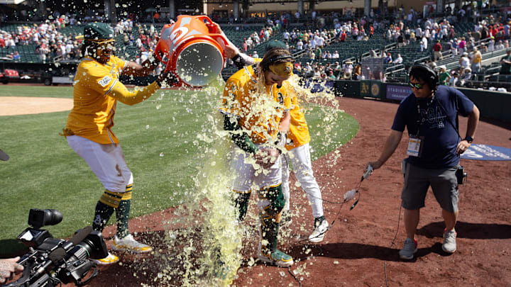 May 25, 2025; West Sacramento, California, USA; Athletics catcher Willie MacIver (65) gets doused by his teammates following their 6-5 victory over the Philadelphia Phillies at Sutter Health Park. Mandatory Credit: D. Ross Cameron-Imagn Images
