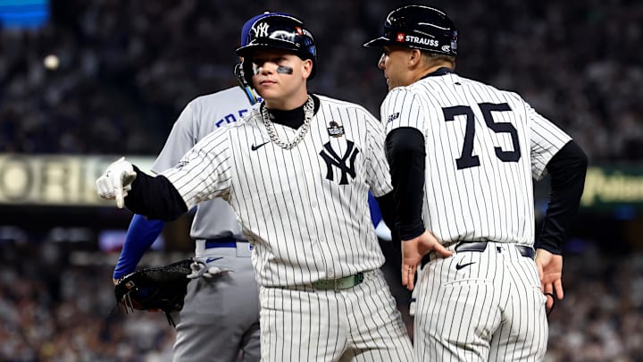 Oct 30, 2024; New York, New York, USA; New York Yankees outfielder Alex Verdugo (24) celebrates with first base coach Travis Chapman (75) after hitting a RBI single during the second inning against the Los Angeles Dodgers in game five of the 2024 MLB World Series at Yankee Stadium. 