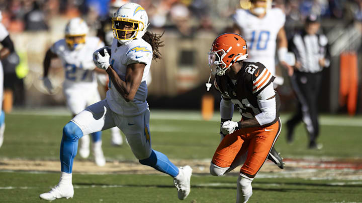 Nov 3, 2024; Cleveland, Ohio, USA; Los Angeles Chargers wide receiver Quentin Johnston (1) runs the ball as Cleveland Browns cornerback Denzel Ward (21) chases him during the second quarter at Huntington Bank Field. Mandatory Credit: Scott Galvin-Imagn Images