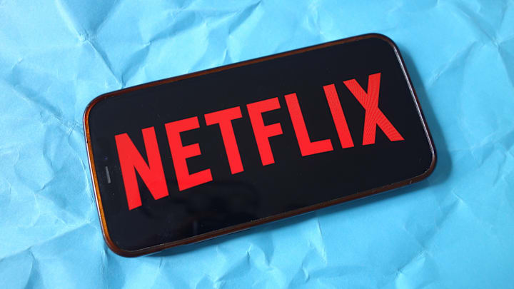 In this photo illustration, the Netflix company logo is seen...