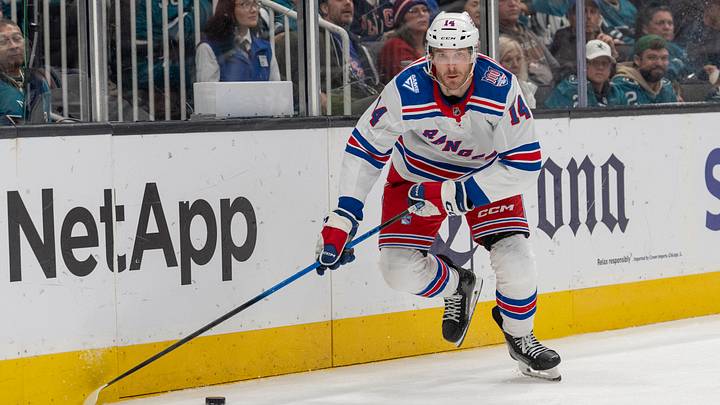 Jan 23, 2026; San Jose, California, USA;  New York Rangers right wing Taylor Raddysh (14) looks to pass the puck during the third period against the San Jose Sharks at SAP Center at San Jose. Mandatory Credit: Stan Szeto-Imagn Images