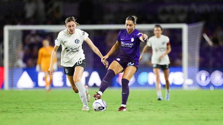 May 11, 2024; Orlando, Florida, USA; Orlando Pride midfielder Ally Lemos (30) battles for the ball against Bay FC midfielder Joelle Anderson (18) during the second half at Inter&Co Stadium. Mandatory Credit: Nathan Ray Seebeck-USA TODAY Sports