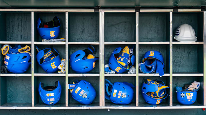 Jun 14, 2025; Omaha, Neb, USA; Helmets sit in the UCLA Bruins dugout before the game against the Murray State Racers at Charles Schwab Field. Mandatory Credit: Dylan Widger-Imagn Images Jun 14, 2025; Omaha, Neb, USA; Helmets sit in the UCLA Bruins dugout before the game against the Murray State Racers at Charles Schwab Field. Mandatory Credit: Dylan Widger-Imagn Images