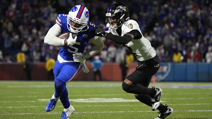 Buffalo Bills wide receiver Joshua Palmer (5) runs the ball against Baltimore Ravens cornerback Nate Wiggins (2) during the fourth quarter at Highmark Stadium. 