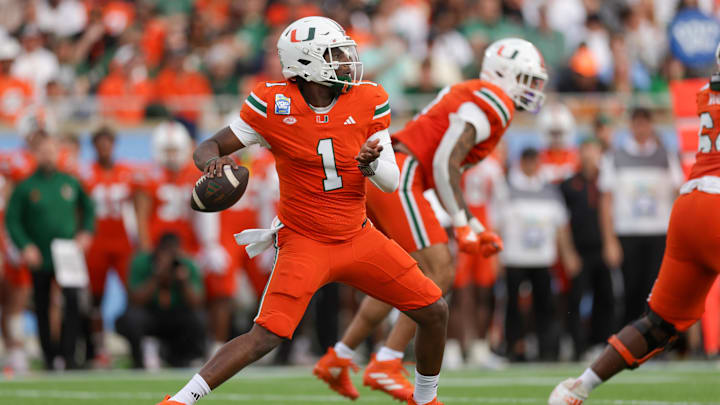 Dec 28, 2024; Orlando, FL, USA; Miami Hurricanes quarterback Cam Ward (1) drops back to pass against the Iowa State Cyclones in the first quarter during the Pop Tarts bowl at Camping World Stadium. Mandatory Credit: Nathan Ray Seebeck-Imagn Images
