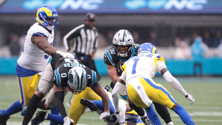 Nov 30, 2025; Charlotte, North Carolina, USA; Carolina Panthers running back Chuba Hubbard (30) rushes as Los Angeles Rams cornerback Emmanuel Forbes Jr. (1) defends during the fourth quarter at Bank of America Stadium. Mandatory Credit: Scott Kinser-Imagn Images