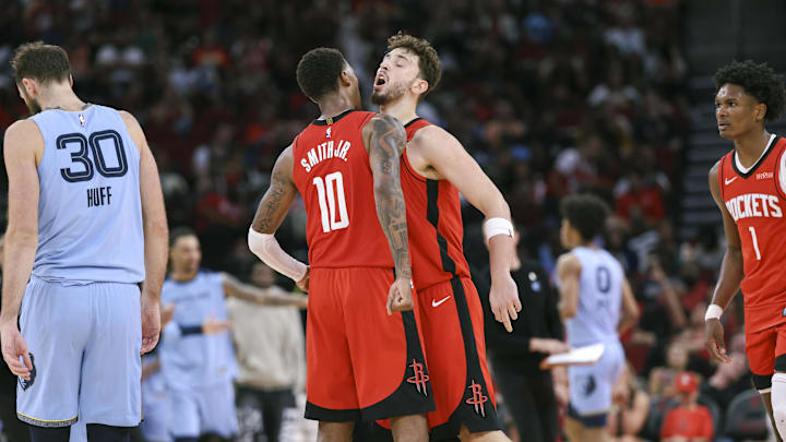 Oct 25, 2024; Houston, Texas, USA; Houston Rockets center Alperen Sengun (28) celebrates with forward Jabari Smith Jr. (10) after a play during the third quarter against the Memphis Grizzlies at Toyota Center. Mandatory Credit: Troy Taormina-Imagn Images