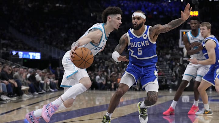 Nov 23, 2024; Milwaukee, Wisconsin, USA; Charlotte Hornets guard LaMelo Ball (1) drives to the basket against Milwaukee Bucks guard Gary Trent Jr. (5) in the second half at Fiserv Forum. Mandatory Credit: Michael McLoone-Imagn Images