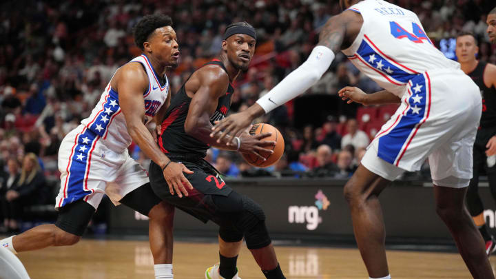Apr 4, 2024; Miami, Florida, USA;  Miami Heat forward Jimmy Butler (22) drives to the basket as Philadelphia 76ers guard Kyle Lowry (7) and forward Paul Reed (44) defend during the first half at Kaseya Center. Mandatory Credit: Jim Rassol-USA TODAY Sports