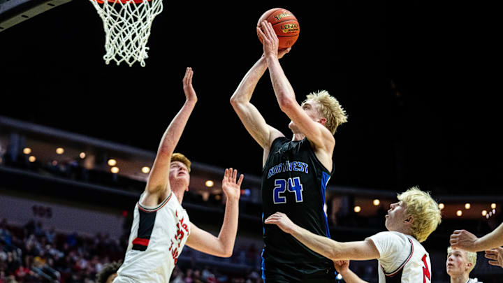 Waukee Northwest's Colin Rice (24) takes a shot over the Cedar Falls defenders on Wednesday, March 12, 2025, at Wells Fargo Arena.
