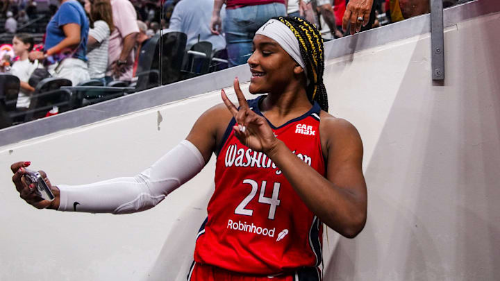 Washington Mystics forward Aaliyah Edwards takes a photo with a during the game against the Indiana Fever. 