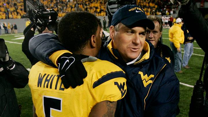 Nov 8, 2007; Morgantown, WV, USA;  West Virginia Mountaineers head coach Rich Rodriguez (right) hugs quarterback Patrick White (5) after defeating the Louisville Cardinals 38-31 at Milan Puskar Stadium in Morgantown, WV.  White scored the game-winning touchdown on a 50 yard run.  Mandatory Credit: James Lang-USA TODAY Sports