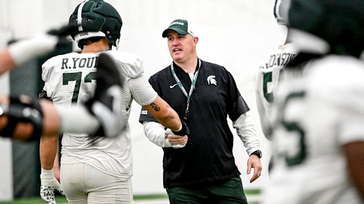 Michigan State's head coach Pat Fitzgerald, right, talks with Rustin Young during spring football practice on Tuesday, April 14, 2026, in East Lansing.