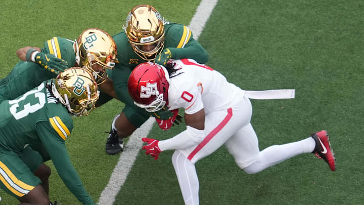 Nov 29, 2025; Waco, Texas, USA; Houston Cougars wide receiver Amare Thomas (0) makes a catch before being tackled by Baylor Bears safety DJ Coleman (33) during the first half at McLane Stadium. Mandatory Credit: Chris Jones-Imagn Images Nov 29, 2025; Waco, Texas, USA; Houston Cougars wide receiver Amare Thomas (0) makes a catch before being tackled by Baylor Bears safety DJ Coleman (33) during the first half at McLane Stadium. Mandatory Credit: Chris Jones-Imagn Images