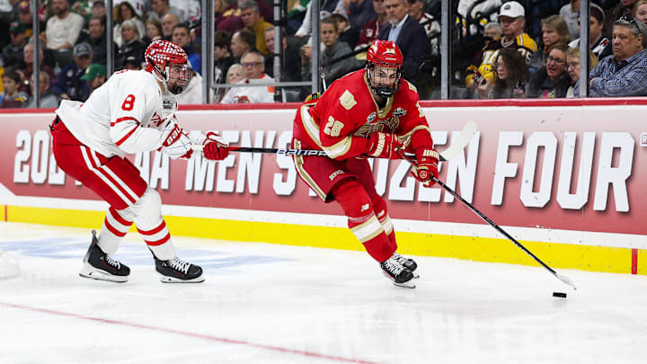 Apr 11, 2024; Saint Paul, Minnesota, USA; Denver Pioneers defenseman Zeev Buium (28) skates with the puck as Boston University Terriers defenseman Cade Webber (8) defends during the third period in the semifinals of the 2024 Frozen Four college ice hockey tournament at Xcel Energy Center. Mandatory Credit: Matt Krohn-Imagn Images
