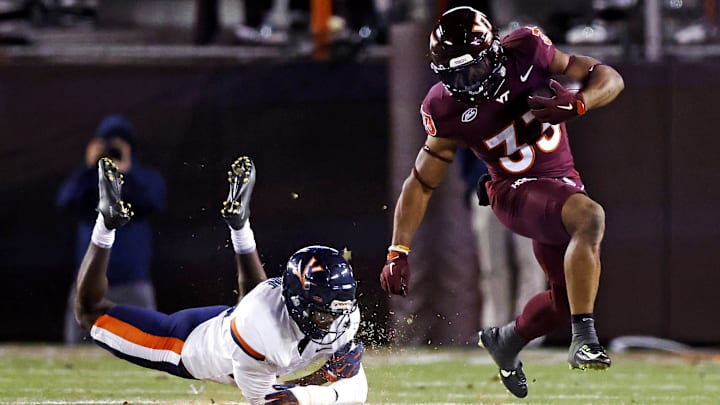 Virginia Tech Hokies running back Bhayshul Tuten runs the ball against Virginia Cavaliers defensive end Miles Greene.