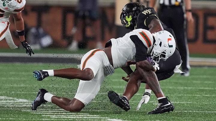 Sep 18, 2026; Winston-Salem, North Carolina, USA; Miami (FL) Hurricanes safety Zechariah Poyser (7) tackles Wake Forest Demon Deacons tight end Kamrean Johnson (12) during the first half at Allegacy Federal Credit Union Stadium. Mandatory Credit: Jim Dedmon-Imagn Images Sep 18, 2026; Winston-Salem, North Carolina, USA; Miami (FL) Hurricanes safety Zechariah Poyser (7) tackles Wake Forest Demon Deacons tight end Kamrean Johnson (12) during the first half at Allegacy Federal Credit Union Stadium. Mandatory Credit: Jim Dedmon-Imagn Images