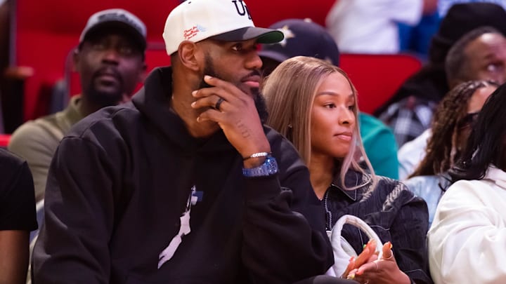 Los Angeles Lakers forward Lebron James (left) and wife Savannah James courtside during the McDonald's All American Boy's high school basketball game at Toyota Center.