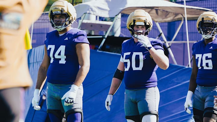 Drew Azzopardi (74), Carver Willis (50) and Elishah Jackett (76) wait for the next UW spring drill. 