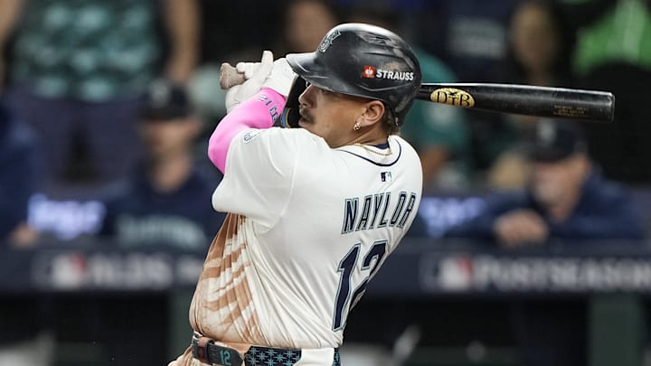 Oct 10, 2025; Seattle, Washington, USA; Seattle Mariners first baseman Josh Naylor (12) singles against the Detroit Tigers during the ninth inning during game five of the ALDS round for the 2025 MLB playoffs at T-Mobile Park. Mandatory Credit: Stephen Brashear-Imagn Images