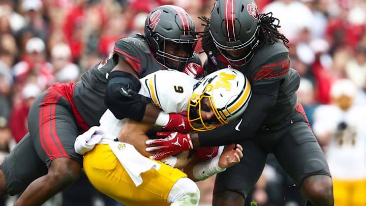 Nov 22, 2025; Norman, Oklahoma, USA;  Oklahoma Sooners linebacker Kendal Daniels (5) tackles Missouri Tigers quarterback Beau Pribula (9) during the second half at Gaylord Family-Oklahoma Memorial Stadium. Mandatory Credit: Kevin Jairaj-Imagn Images