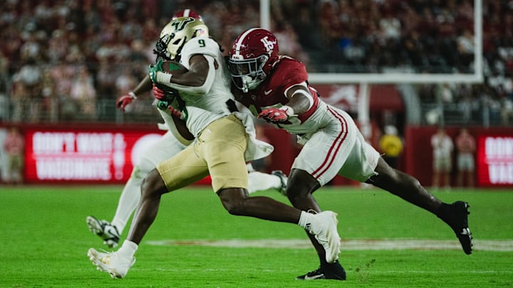 Sep 7, 2024; Tuscaloosa, Alabama, USA;  Alabama Crimson Tide linebacker Justin Jefferson (15) dives for South Florida Bulls running back Ta'Ron Keith (9) as he runs the ball down the field during the fourth quarter at Bryant-Denny Stadium. Mandatory Credit: William McLelland-Imagn Images