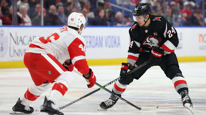 Mar 12, 2024; Buffalo, New York, USA;  Buffalo Sabres center Dylan Cozens (24) carries the puck up ice as Detroit Red Wings defenseman Jeff Petry (46) defends during the second period at KeyBank Center. Mandatory Credit: Timothy T. Ludwig-Imagn Images