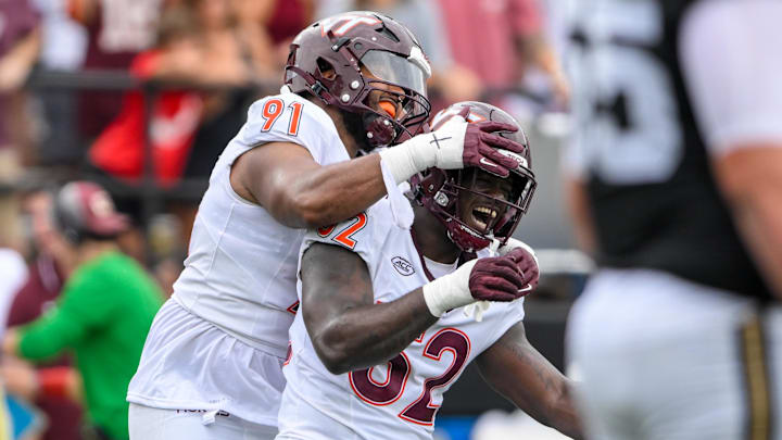 Aug 31, 2024; Nashville, Tennessee, USA;  Virginia Tech Hokies defensive lineman Wilfried Pene (91) and Virginia Tech Hokies defensive lineman Antwaun Powell-Ryland (52) celebratione a sack against the Vanderbilt Commodores during the first half at FirstBank Stadium. Mandatory Credit: Steve Roberts-Imagn Images