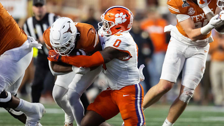 Dec 21, 2024; Austin, Texas, USA; Clemson Tigers linebacker Barrett Carter (0) tackles Texas Longhorns running back Jaydon Blue (23) during the CFP National playoff first round at Darrell K Royal-Texas Memorial Stadium. 