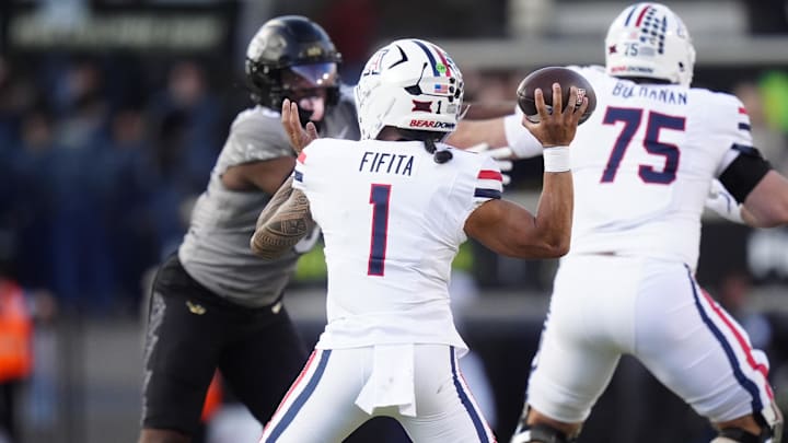 Nov 1, 2025; Boulder, Colorado, USA; Arizona Wildcats quarterback Noah Fifita (1) prepares to throw a touchdown pass in the first quarter against the Colorado Buffaloes at Folsom Field. Mandatory Credit: Ron Chenoy-Imagn Images
