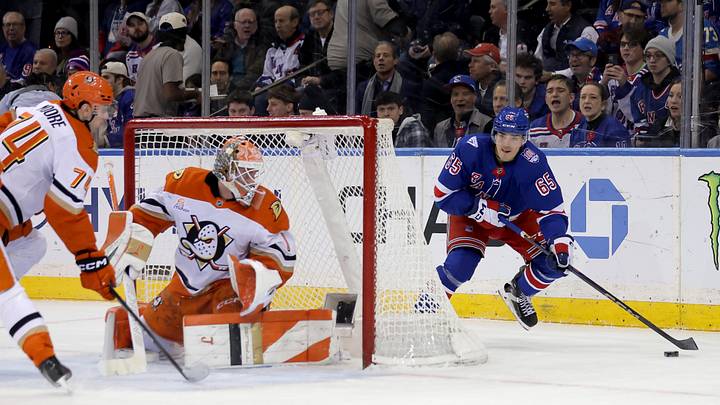 Dec 15, 2025; New York, New York, USA; New York Rangers left wing Brett Berard (65) controls the puck against Anaheim Ducks defenseman Ian Moore (74) and goaltender Lukas Dostal (1) during the first period at Madison Square Garden. Mandatory Credit: Brad Penner-Imagn Images