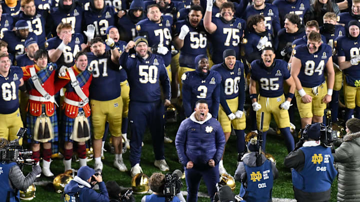 Dec 20, 2024; Notre Dame, Indiana, USA; Notre Dame Fighting Irish head coach Marcus Freeman celebrates with his team after defeating the Indiana Hoosiers in the first round of the College Football Playoff at Notre Dame Stadium. Mandatory Credit: Matt Cashore-Imagn Images Dec 20, 2024; Notre Dame, Indiana, USA; Notre Dame Fighting Irish head coach Marcus Freeman celebrates with his team after defeating the Indiana Hoosiers in the first round of the College Football Playoff at Notre Dame Stadium. Mandatory Credit: Matt Cashore-Imagn Images