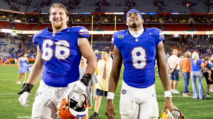 Florida Gators offensive lineman Jake Slaughter and tight end Arlis Boardingham walk off the field during the second half against the Vanderbilt Commodores.
