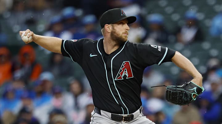 Apr 20, 2025; Chicago, Illinois, USA; Arizona Diamondbacks starting pitcher Merrill Kelly (29) delivers a pitch against the Chicago Cubs during the first inning at Wrigley Field. Mandatory Credit: Kamil Krzaczynski-Imagn Images