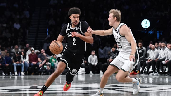 Dec 8, 2024; Brooklyn, New York, USA; Brooklyn Nets forward Cameron Johnson (2) drives to the basket while being defended by Milwaukee Bucks guard AJ Green (20) during the first half at Barclays Center. Mandatory Credit: John Jones-Imagn Images