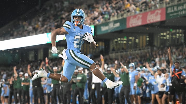 Makhi Hughes (21) runs the ball for the Tulane Green Wave. Makhi Hughes (21) runs the ball for the Tulane Green Wave.