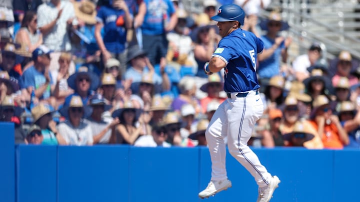 Mar 13, 2025; Dunedin, Florida, USA; Toronto Blue Jays outfielder Daulton Varsho (5) celebrates after hitting a two-run home run against the Baltimore Orioles in the fifth inning during spring training at TD Ballpark. 