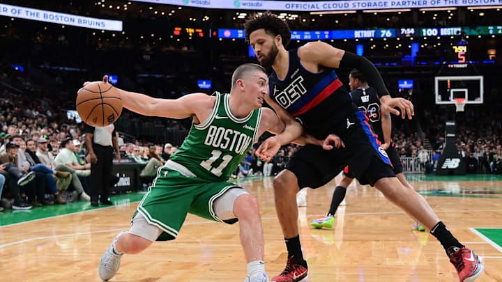 Dec 12, 2024; Boston, Massachusetts, USA;  Boston Celtics guard Payton Pritchard (11) drives to the basket against Detroit Pistons guard Cade Cunningham (2) during the second half at TD Garden. Mandatory Credit: Eric Canha-Imagn Images