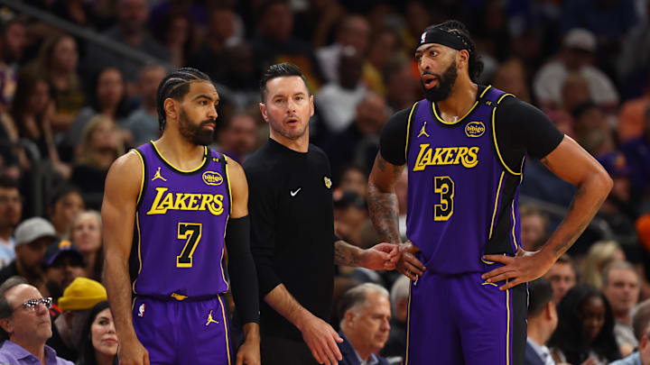 Oct 28, 2024; Phoenix, Arizona, USA; Los Angeles Lakers head coach JJ Redick with guard Gabe Vincent (7) and forward Anthony Davis (3) against the Phoenix Suns at Footprint Center. Mandatory Credit: Mark J. Rebilas-Imagn Images