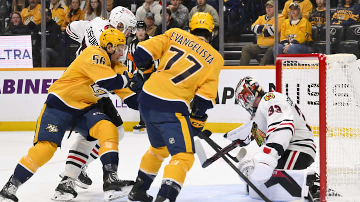 Jan 10, 2026; Nashville, Tennessee, USA;  Chicago Blackhawks goaltender Drew Commesso (33) blocks the shot of Nashville Predators left wing Erik Haula (56) during the first period at Bridgestone Arena. Mandatory Credit: Steve Roberts-Imagn Images