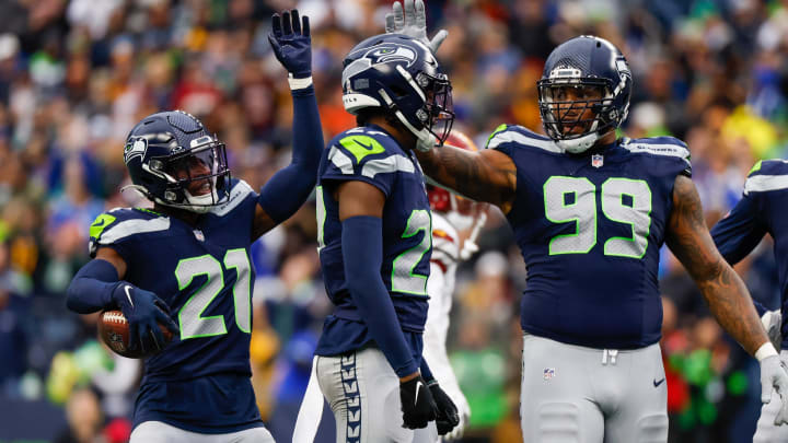 Nov 12, 2023; Seattle, Washington, USA; Seattle Seahawks cornerback Devon Witherspoon (21), cornerback Riq Woolen (27) and defensive end Leonard Williams (99) celebrate following a play against the Washington Commanders during the second quarter at Lumen Field. Mandatory Credit: Joe Nicholson-USA TODAY Sports