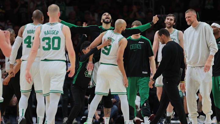 Mar 14, 2025; Miami, Florida, USA: Boston Celtics forward Jayson Tatum (0) celebrates with guard Derrick White (9) against the Miami Heat during the fourth quarter at Kaseya Center. Mandatory Credit: Sam Navarro-Imagn Images