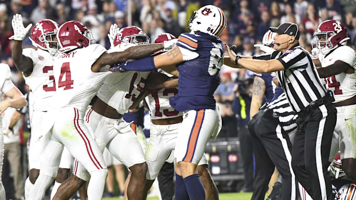 Nov 25, 2023; Auburn, Alabama, USA; Players from the Alabama Crimson Tide and Auburn Tigers get into a shoving match late in a game at Jordan-Hare Stadium. Alabama won 27-24. Mandatory Credit: Gary Cosby Jr.-Imagn Images