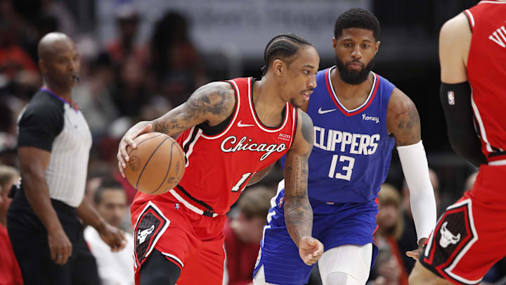 Mar 31, 2022; Chicago, Illinois, USA; Chicago Bulls forward DeMar DeRozan (11) drives to the basket against LA Clippers guard Paul George (13) during the first half at United Center. Mandatory Credit: Kamil Krzaczynski-USA TODAY Sports