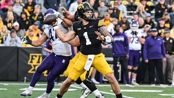 Oct 26, 2024; Iowa City, Iowa, USA; Iowa Hawkeyes quarterback Brendan Sullivan (1) throws a pass against the Northwestern Wildcats during the fourth quarter at Kinnick Stadium. Mandatory Credit: Jeffrey Becker-Imagn Images