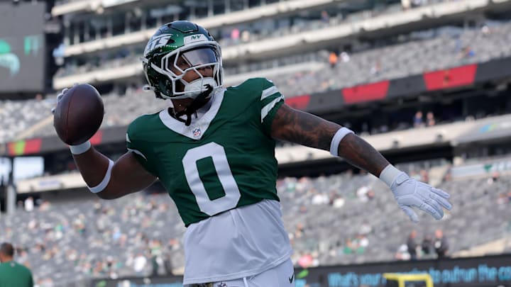 New York Jets running back Braelon Allen (0) plays catch with fans before a game against the Indianapolis Colts at MetLife Stadium. 