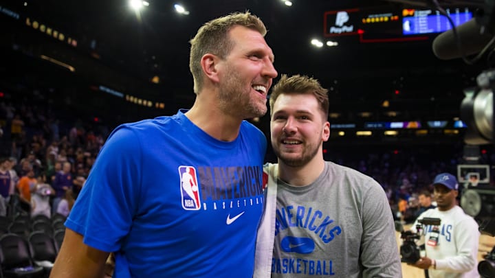 May 15, 2022; Phoenix, Arizona, USA; Dallas Mavericks oguard Luka Doncic (right) with former player Dirk Nowitzki against the Phoenix Suns in game seven of the second round for the 2022 NBA playoffs at Footprint Center. Mandatory Credit: Mark J. Rebilas-Imagn Images